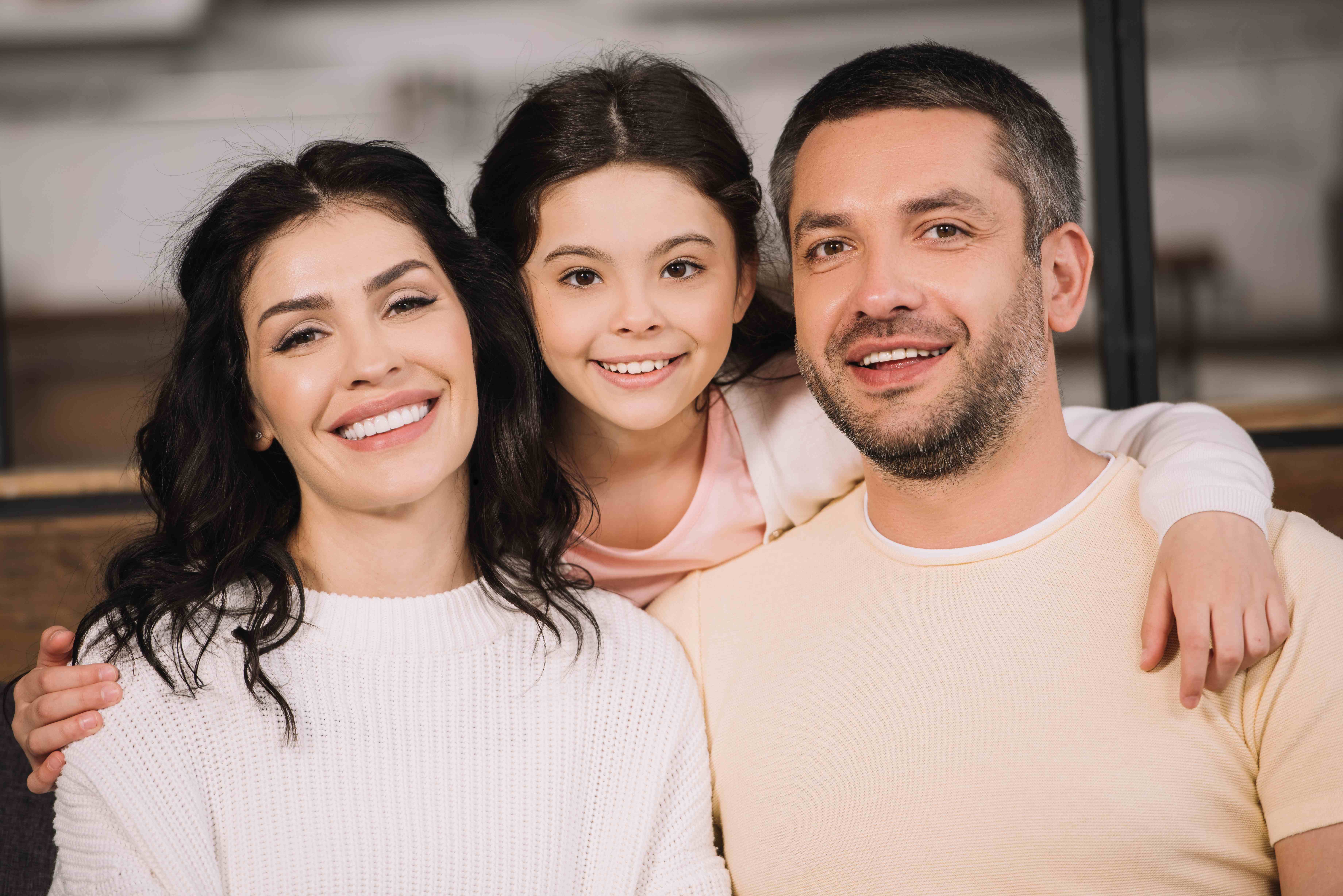Family smiling together at home