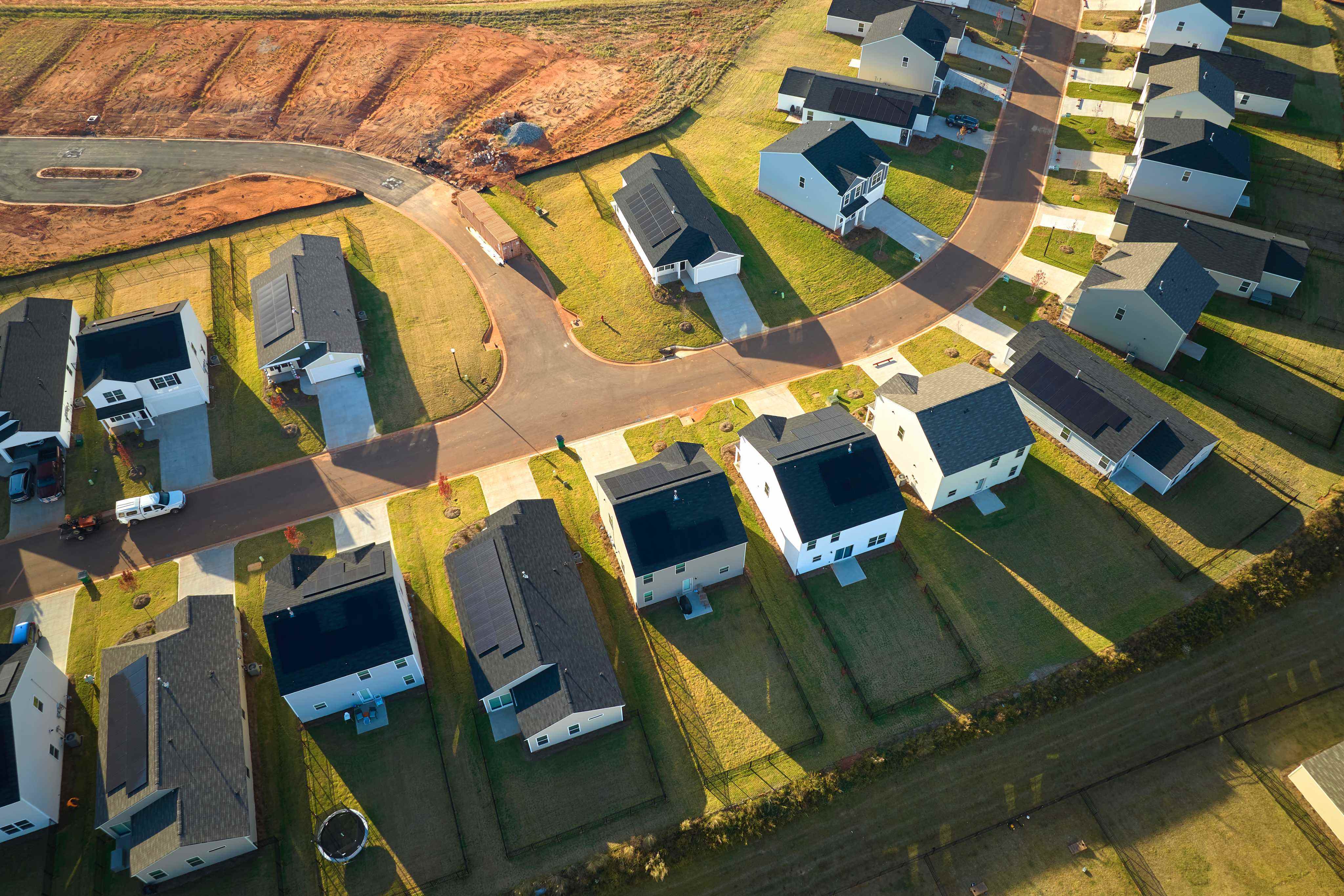 Aerial view of neighbourhood homes with rooftop solar and connected street network